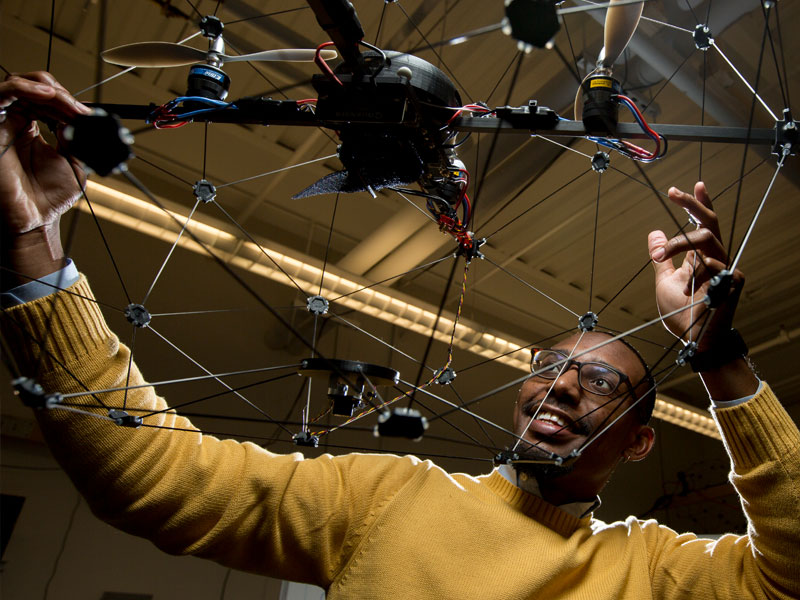 George Holmes holding a drone